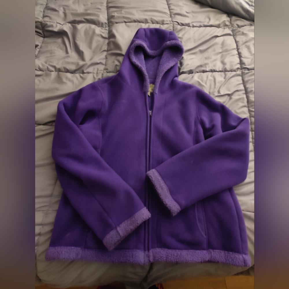Plush purple jacket with hood, vibrant.